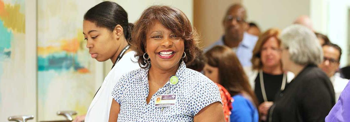 Woman smiling standing in line at Christee Miree breakfast