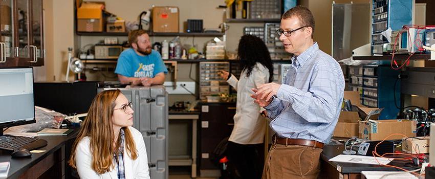 A professor talking to a student in the lab.