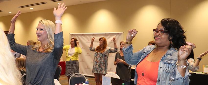 Females holding up hands in workshop