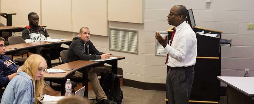 Professor lecturing students about the effects of parenting and pregnancy.