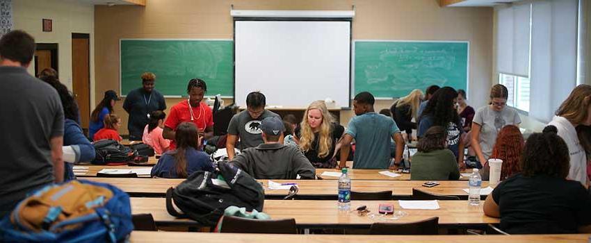 Professor lecturing students about the effects of parenting and pregnancy.