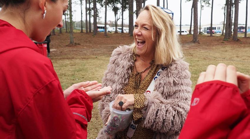 First Lady laughing and handing out buttons.