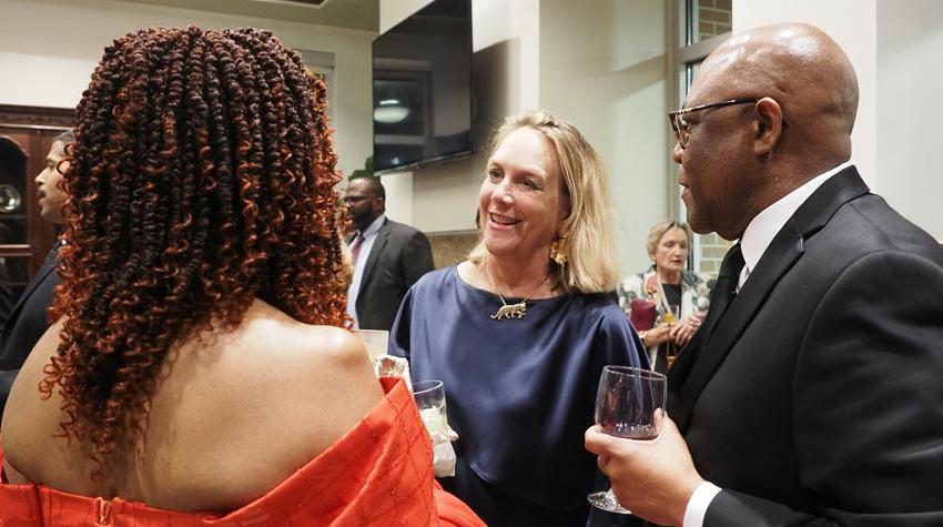 First Lady at event speaking to two people.