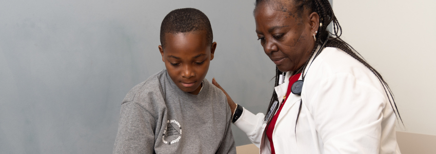 Nurse practitioner examines a young, male patient.