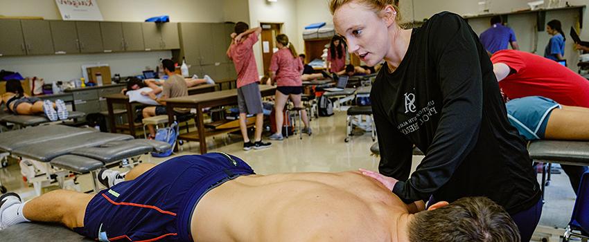 Image of students in PT lab.