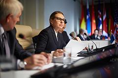 Woman speaking at politcial meeting.