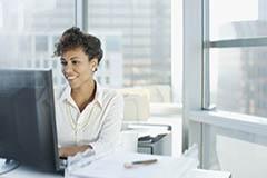 Woman working at computer typing