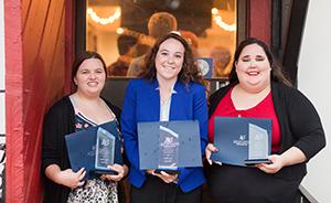 Three female students with awards.