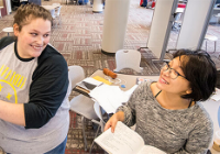 A staff member working with a student in Academic Excellence.