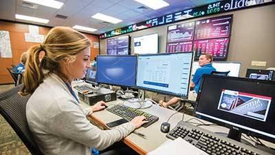 Female student working in Mitchell College of Business Lab.