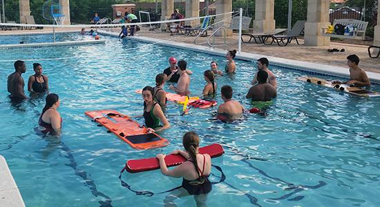 Lifeguards swimming in pool