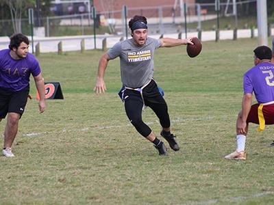 Students playing flag football on campus.