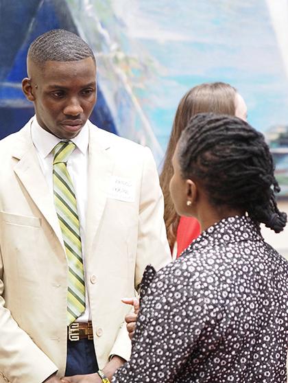 Student speaking with employer ar career fair event.