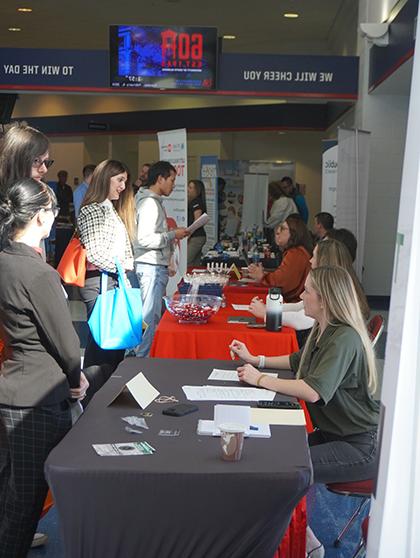 Students talking to employers at career fair.