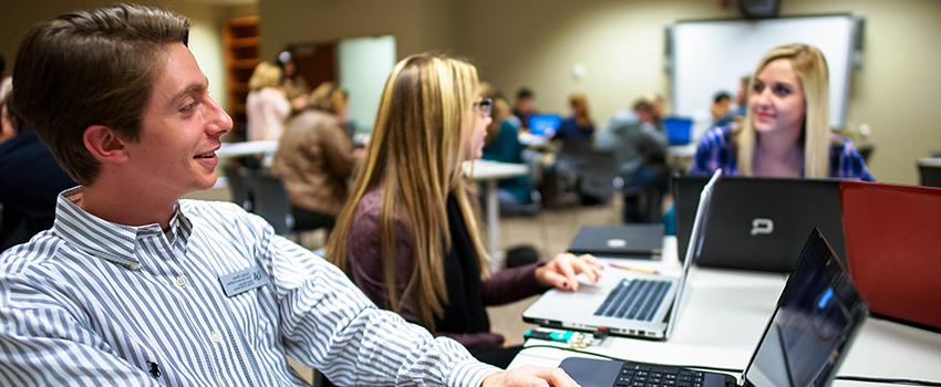 Three students working on their computers