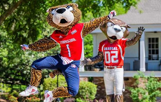 Southpaw kicking up his heels in front of Southpaw statue.