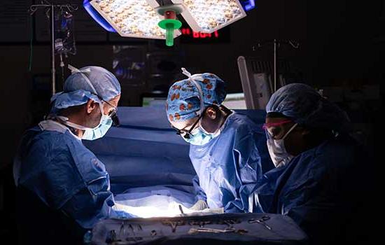 Doctors working on patient in surgery.