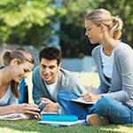 Student sitting on grass studying