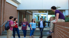 Group of six students talking outside