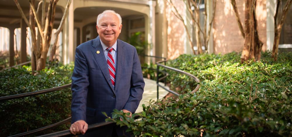 President Jo Bonner standing in front of Admin building outside.