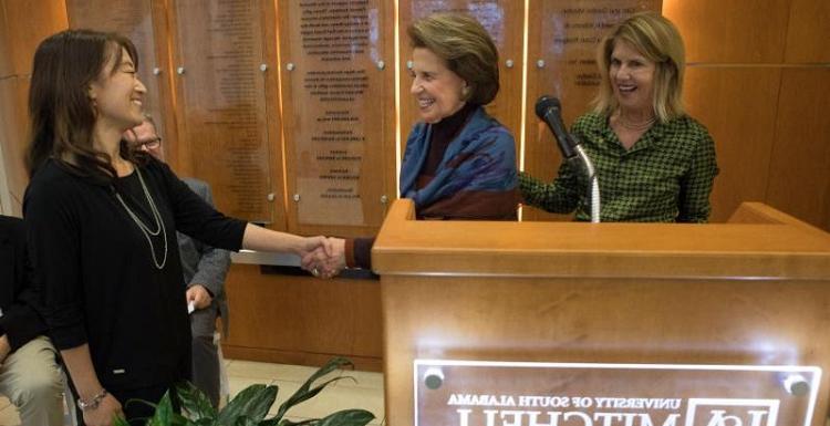 Dr. Erin Eun-Young Ahn, right, is congratulated by USA Trustee Arlene Mitchell, wife of the late Mayer Mitchell. She is joined by Vice President for Development and Alumni Relations Margaret Sullivan. 