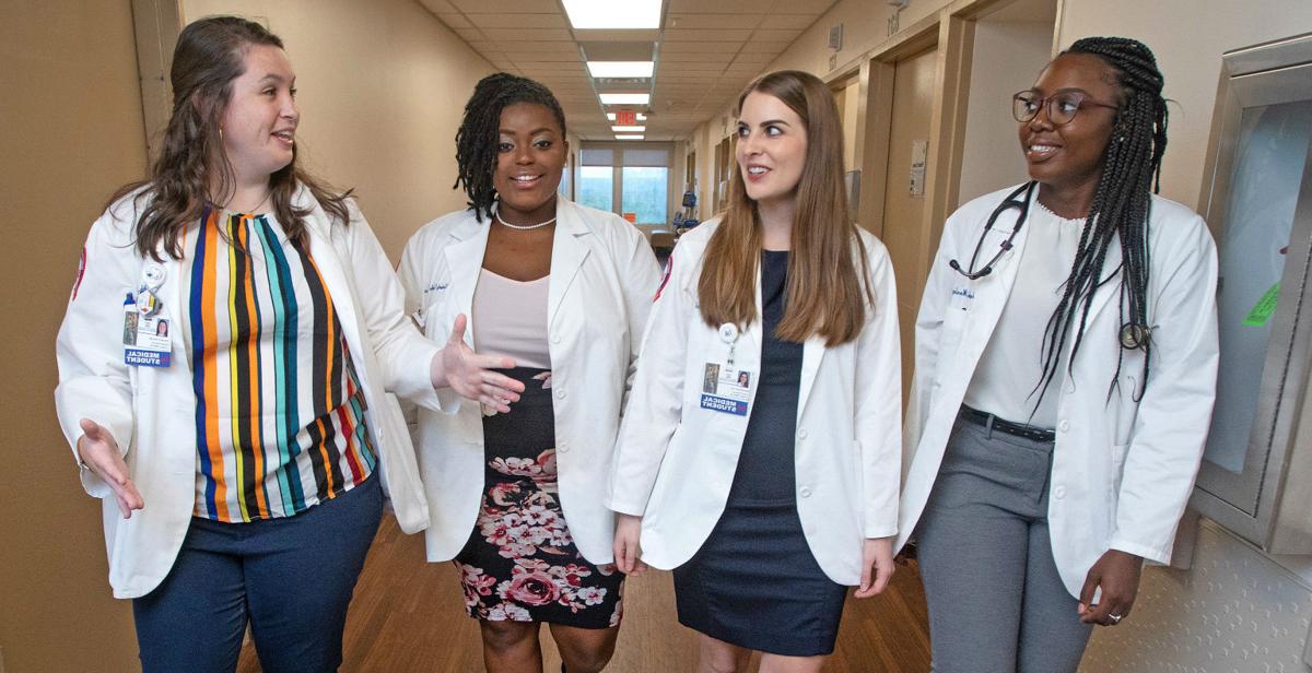 Angela Mosley-Johnson, Samantha Lee, Kimberly McWilliams and Hannah Brooks chat during a break in clinical rotations at USA Health University Hospital. The third-year students at the University of South Alabama College of Medicine have been awarded scholarships from Blue Cross and Blue Shield of Alabama as part of initiative to improve access to healthcare in underserved areas of the state.