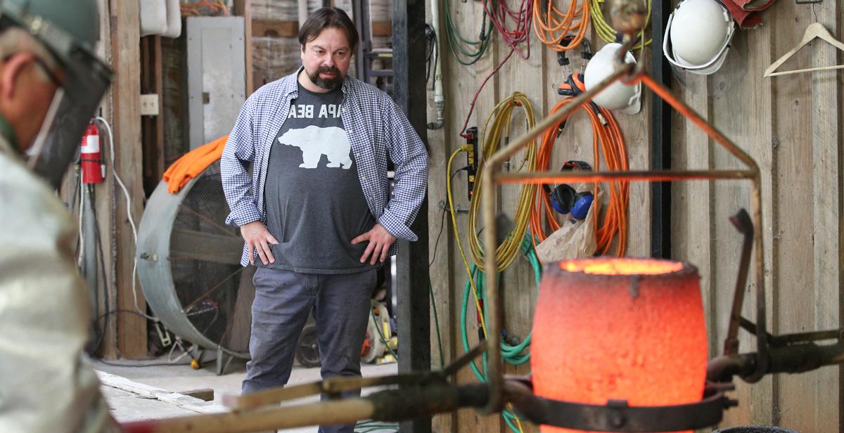 Fernando Guérard, a graduate student at the University of South Alabama, watches as his sculpture of Chief Calvin McGhee is being cast in bronze at the Fairhope Foundry. “This man, his humbleness and his honesty, I really connected with,” Guerard says. 