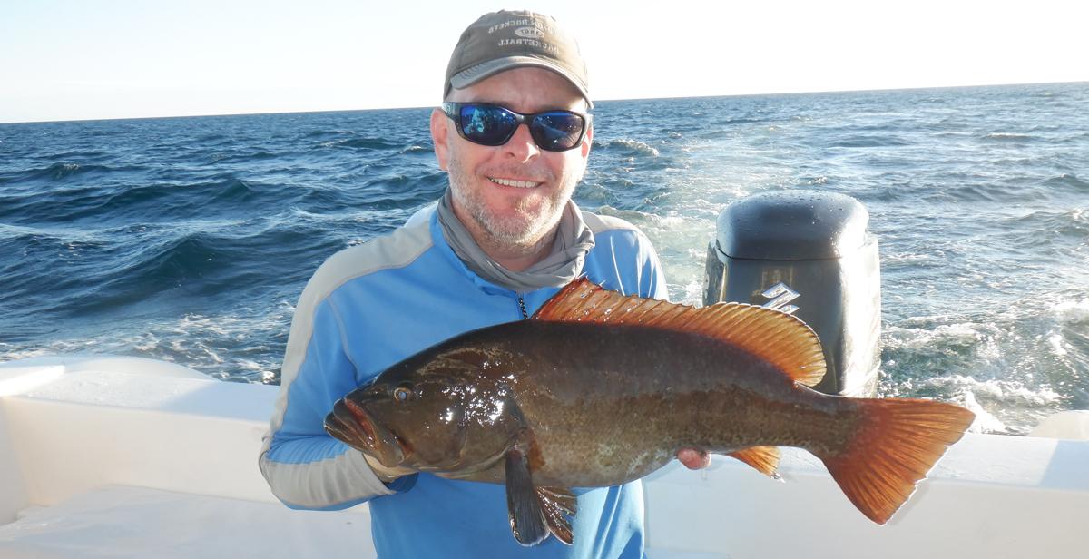 Dr. Ronnie Baker, an assistant professor of marine science at the University of South Alabama, holds a grouper off San Cristobal Island in the Galapagos. When he returns for research, Baker plans aims to identify coastal nursery habitats for fisheries species.