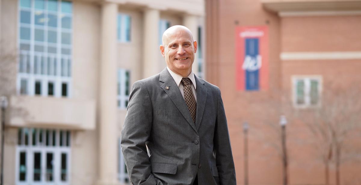 Dr. Todd R. Andel in front of the School of Computing at the University of South Alabama.  The school is designated as a National Center of Academic Excellence in Cyber Defense by the National Security Agency and the Department of Homeland Security. 