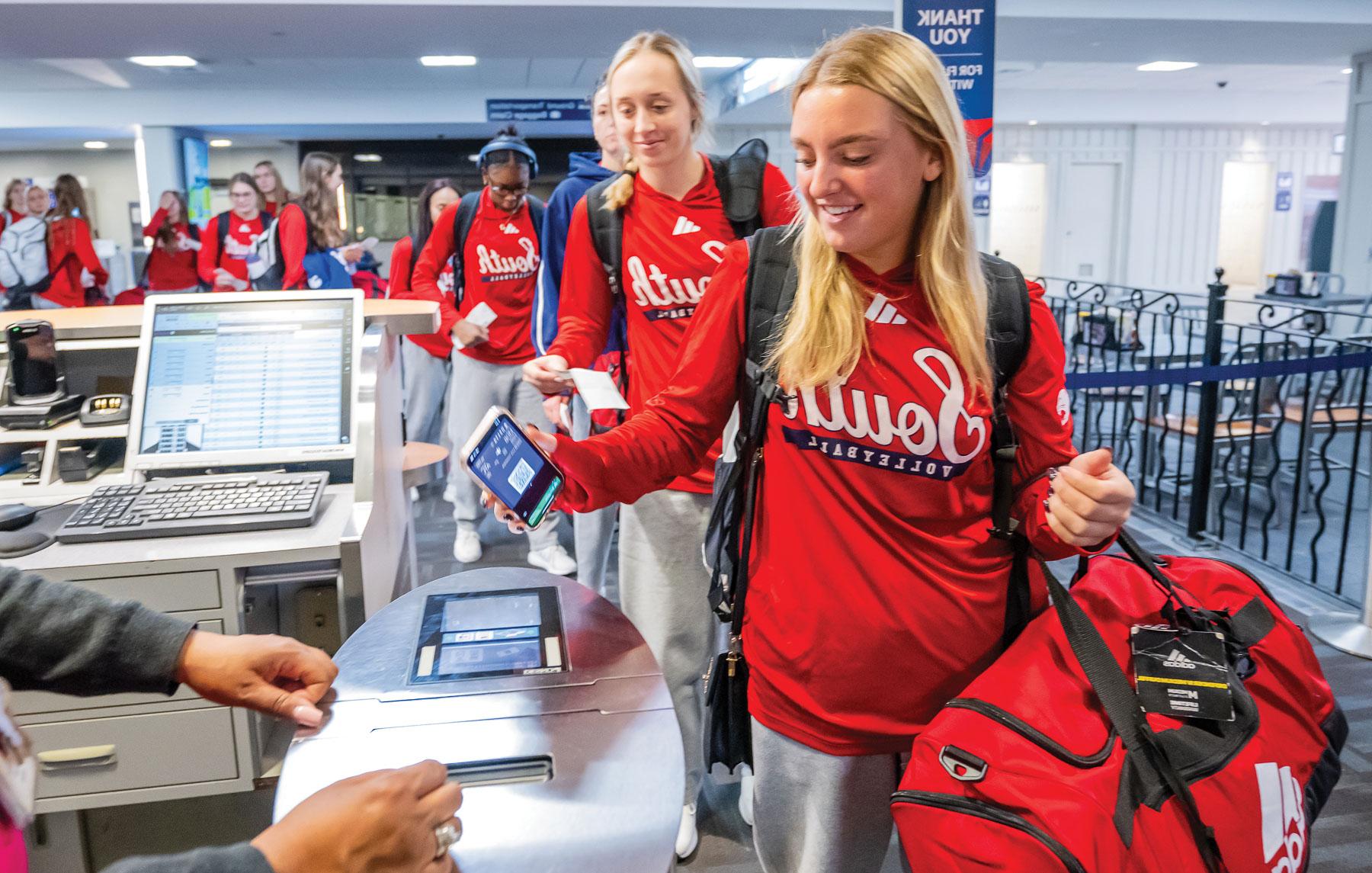 At 5:42 on Oct. 31, the volleyball team boards a flight at Mobile Regional Airport on their way to a two-match sweep of James Madison University in Harrisonburg, Virginia. 