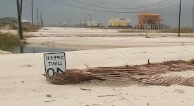 Stephanie Smallegan recieved a 2019 FDCF award to submit an NSF CAREER proposal for her work on barrier islands and hurricanes. Photo is a speed limit sign is partially obscured by sand on Dauphin Island's Bienville Boulevard after Hurricane Nate.