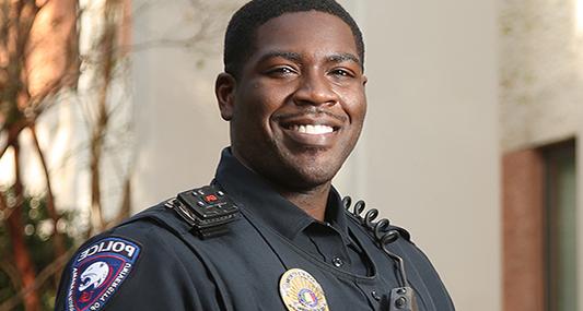 Police Officer smiling in uniform.