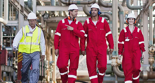 Workers walking in construciton hats on site.